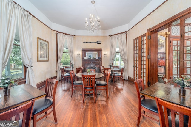 622 Main St, Blackshear, GA 31516 - dining room with french doors, a notable chandelier, and hardwood / wood-style flooring