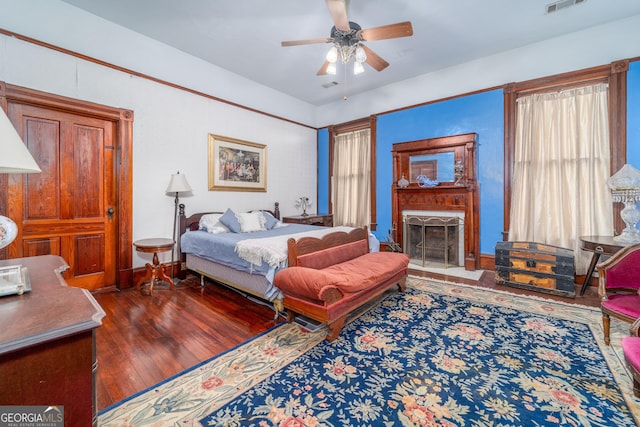 622 Main St, Blackshear, GA 31516 - bedroom with a ceiling fan, a fireplace, visible vents, and hardwood / wood-style floors