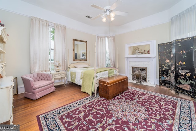 622 Main St, Blackshear, GA 31516 - bedroom featuring ceiling fan, visible vents, a fireplace, and wood finished floors