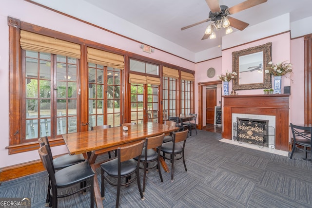 622 Main St, Blackshear, GA 31516 - carpeted dining room with a ceiling fan, a fireplace with flush hearth, and baseboards