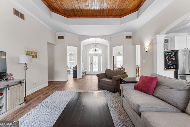 1452 Redwine Rd, Fayetteville, GA 30215 - living area with a tray ceiling, wooden ceiling, light wood finished floors, arched walkways, and ornamental molding