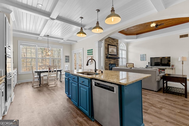 1452 Redwine Rd, Fayetteville, GA 30215 - kitchen with blue cabinetry, dishwasher, wood finished floors, a stone fireplace, and a wood ceiling with exposed beams