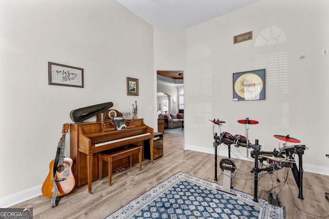 1452 Redwine Rd, Fayetteville, GA 30215 - sitting room featuring wood finished floors, a towering ceiling, and arched walkways
