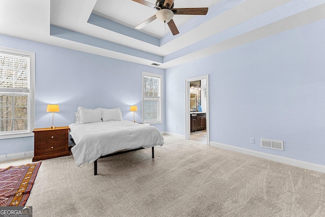 1452 Redwine Rd, Fayetteville, GA 30215 - bedroom featuring light carpet, a tray ceiling, ensuite bath, and a ceiling fan