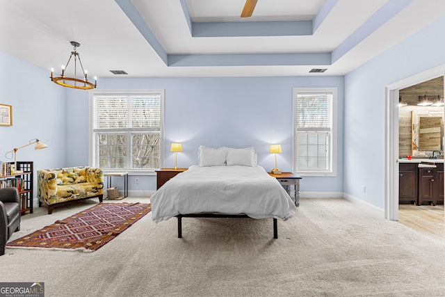 1452 Redwine Rd, Fayetteville, GA 30215 - bedroom featuring a chandelier, light colored carpet, ensuite bathroom, and a ceiling fan