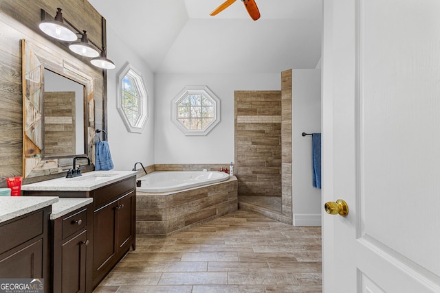 1452 Redwine Rd, Fayetteville, GA 30215 - full bathroom featuring vanity, a bath, vaulted ceiling, ceiling fan, and wood finished floors