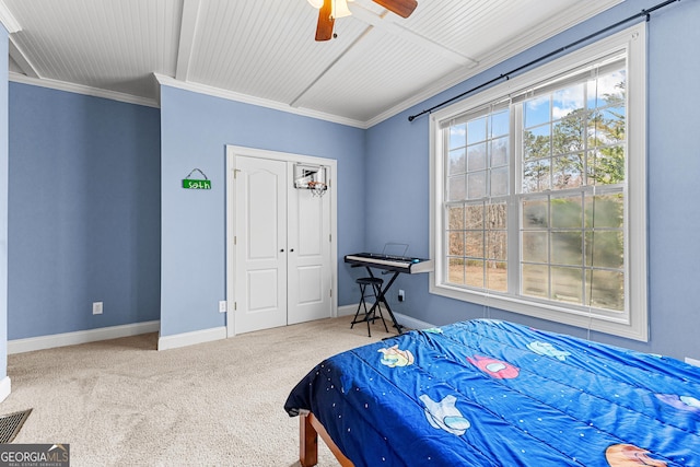 1452 Redwine Rd, Fayetteville, GA 30215 - carpeted bedroom featuring multiple windows, ornamental molding, a ceiling fan, and a closet