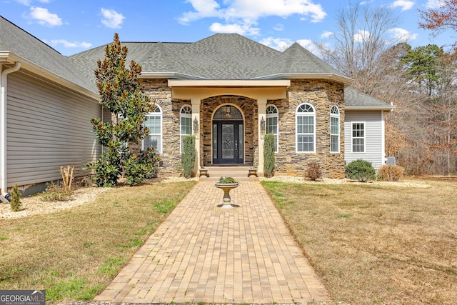 1452 Redwine Rd, Fayetteville, GA 30215 - doorway to property with stone siding, a shingled roof, and a lawn