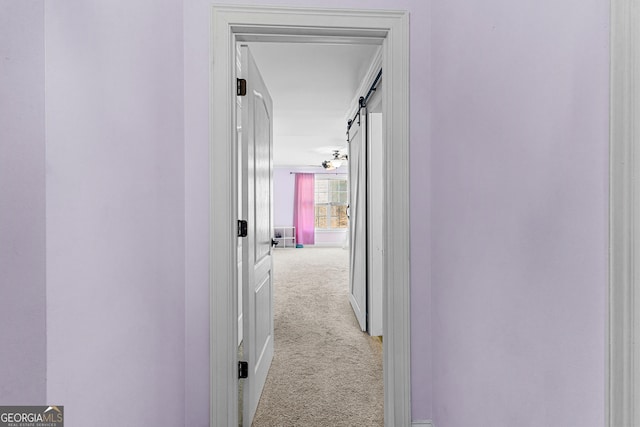 1452 Redwine Rd, Fayetteville, GA 30215 - hallway with carpet floors and a barn door
