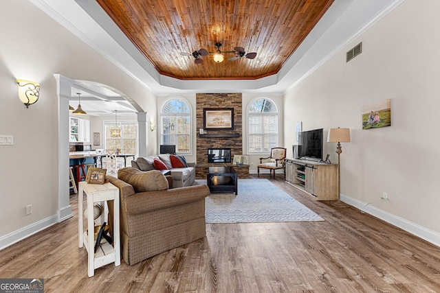 1452 Redwine Rd, Fayetteville, GA 30215 - living area featuring wood ceiling, a raised ceiling, ornamental molding, a ceiling fan, and arched walkways