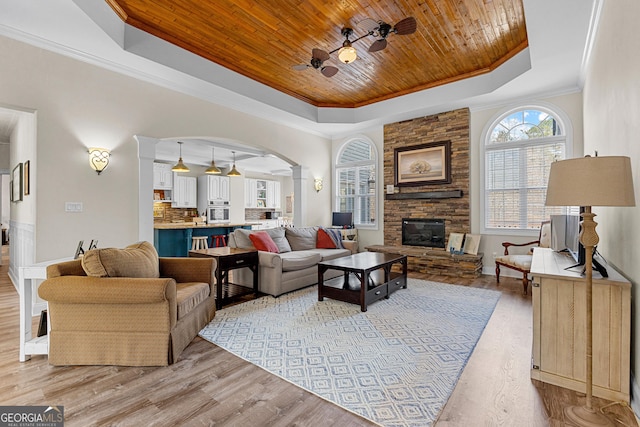 1452 Redwine Rd, Fayetteville, GA 30215 - living area featuring a raised ceiling, a ceiling fan, wooden ceiling, arched walkways, and light wood-style floors