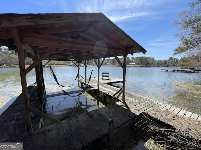 dock area with a water view and boat lift