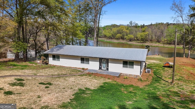 532 Henry Higgins Rd, Jackson, GA 30233 - ranch-style home featuring metal roof, a water view, central air condition unit, and a front lawn