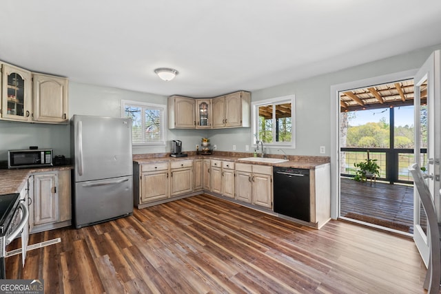 532 Henry Higgins Rd, Jackson, GA 30233 - kitchen featuring appliances with stainless steel finishes, a sink, dark wood finished floors, light brown cabinetry, and glass insert cabinets