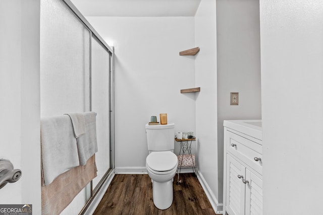 532 Henry Higgins Rd, Jackson, GA 30233 - bathroom with wood finished floors, toilet, a shower stall, vanity, and baseboards