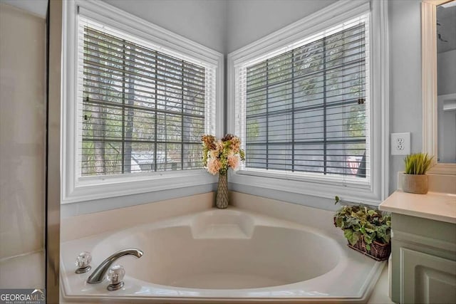 bathroom with vanity and a bath