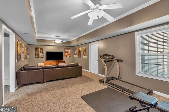 exercise room with baseboards, visible vents, crown molding, and a ceiling fan