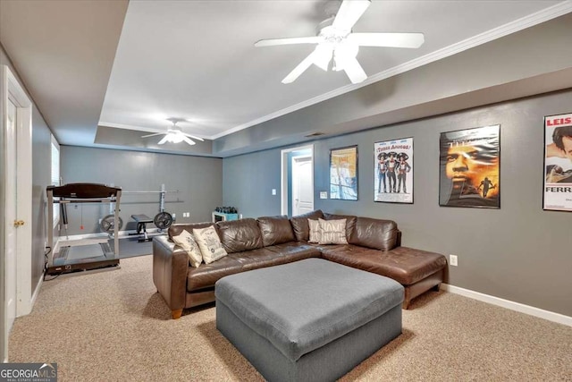 living room featuring baseboards, ceiling fan, crown molding, and light colored carpet
