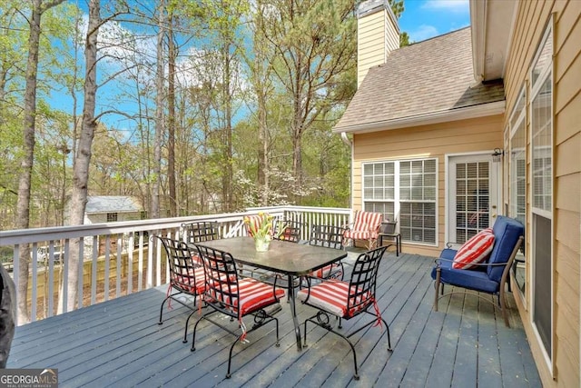 wooden terrace with outdoor dining space