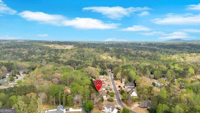drone / aerial view with a wooded view