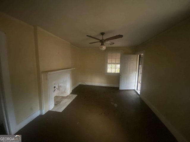unfurnished living room with baseboards and a ceiling fan