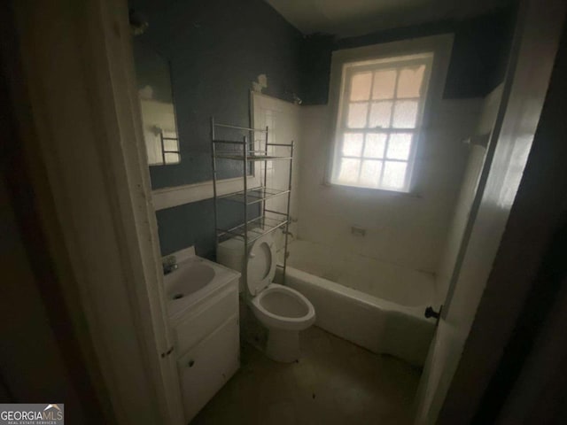 bathroom with toilet, vanity, and washtub / shower combination