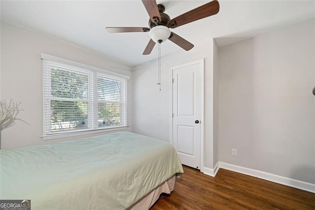 bedroom with baseboards, ceiling fan, and dark wood finished floors