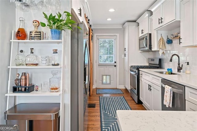 kitchen with white cabinetry, a sink, and stainless steel appliances
