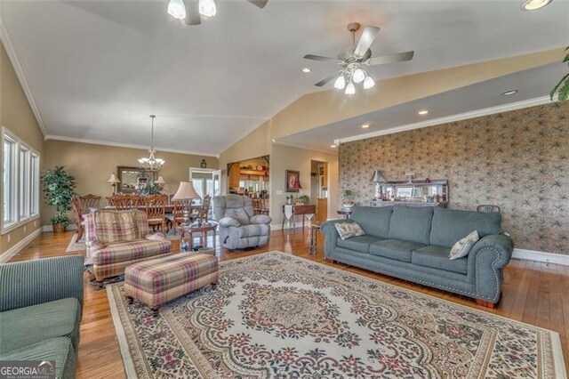 300 Ellis Rd, Rome, GA 30161 - living area with ceiling fan with notable chandelier, wallpapered walls, lofted ceiling, and ornamental molding