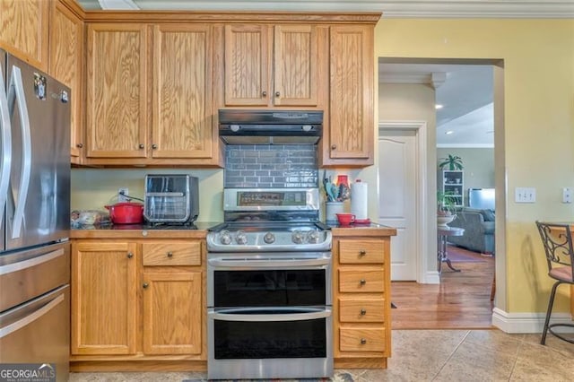 300 Ellis Rd, Rome, GA 30161 - kitchen with backsplash, under cabinet range hood, light tile patterned floors, stainless steel appliances, and ornamental molding