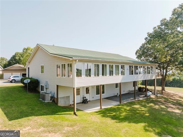 300 Ellis Rd, Rome, GA 30161 - back of property featuring central AC unit, a lawn, and a patio