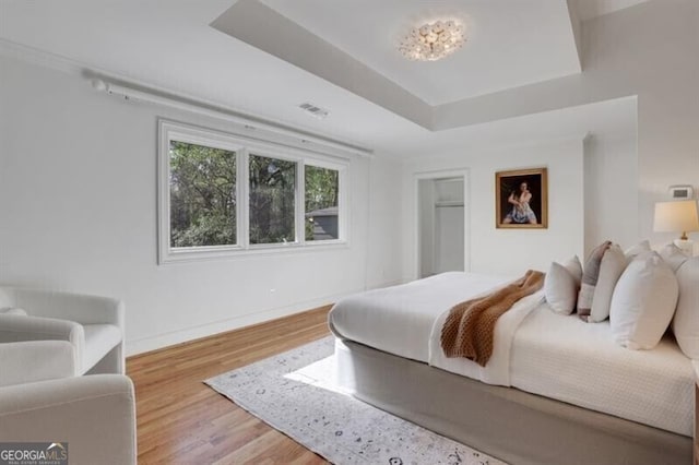 bedroom featuring baseboards and wood finished floors