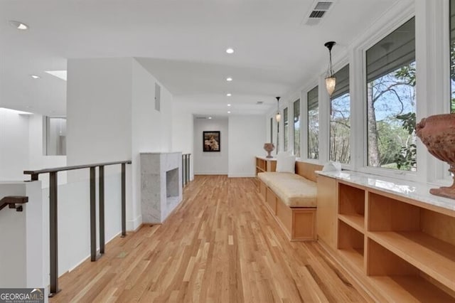 hallway with light wood-style flooring, baseboards, visible vents, and recessed lighting