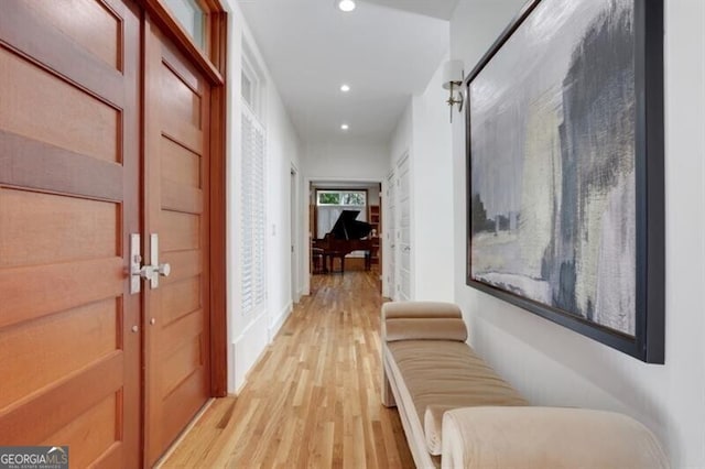 corridor featuring light wood-style flooring and recessed lighting