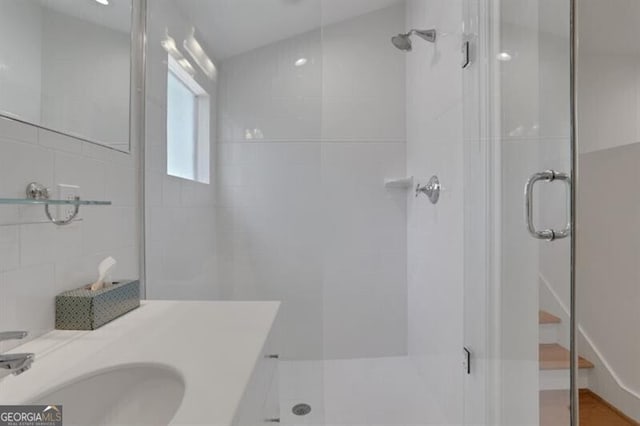 full bathroom with a stall shower and vanity