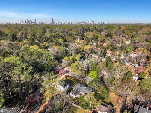 drone / aerial view with a view of trees and a city view