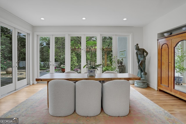 dining room with light wood-style flooring and recessed lighting
