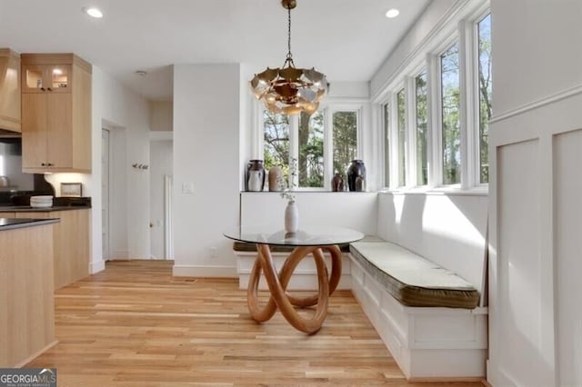 interior space with recessed lighting, light wood finished floors, a notable chandelier, and baseboards