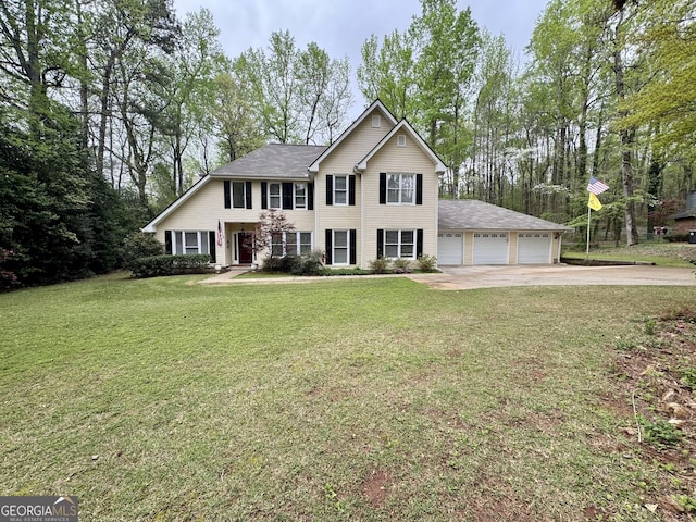 colonial inspired home featuring concrete driveway, a front lawn, a garage, and a shingled roof