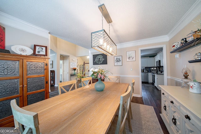 dining area featuring a textured ceiling, a chandelier, ornamental molding, and dark wood-style flooring