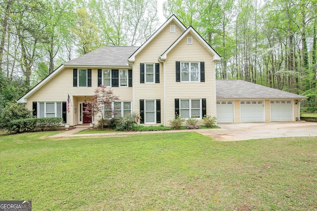 view of front of home with concrete driveway, a garage, and a front yard