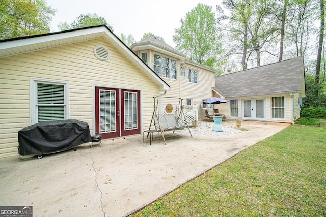 back of property featuring french doors, a patio area, and a yard