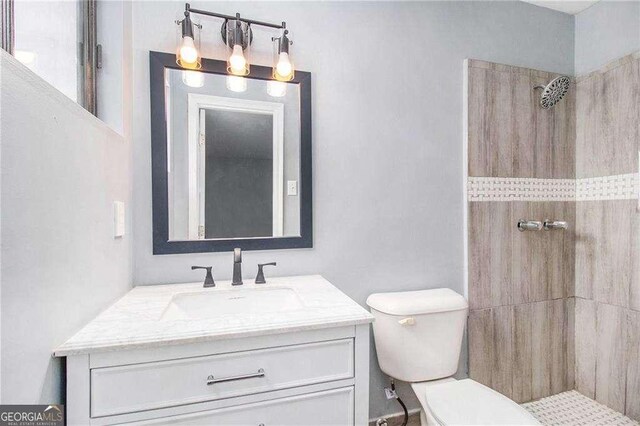 3862 Northstrand Dr, Decatur, GA 30035 - bathroom with toilet, tiled shower, and vanity