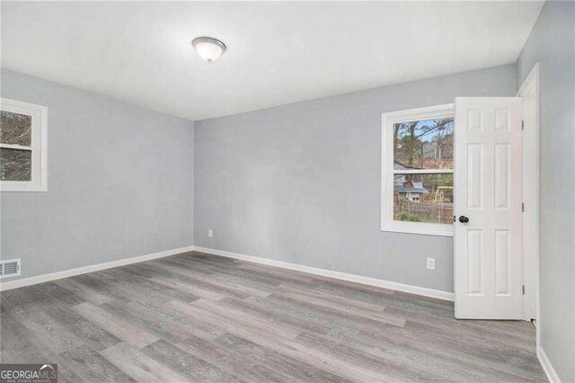 3862 Northstrand Dr, Decatur, GA 30035 - empty room with baseboards, visible vents, and wood finished floors