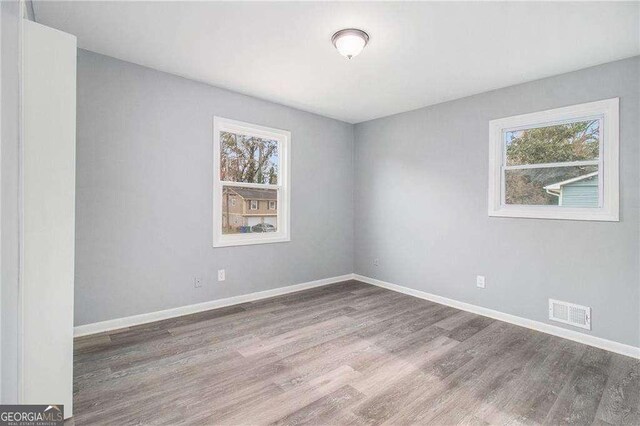 3862 Northstrand Dr, Decatur, GA 30035 - unfurnished room with baseboards, wood finished floors, and a healthy amount of sunlight