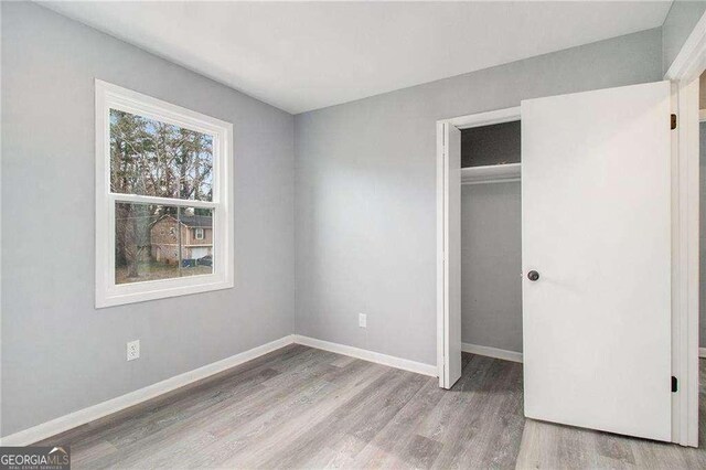 3862 Northstrand Dr, Decatur, GA 30035 - unfurnished bedroom featuring a closet, baseboards, and wood finished floors