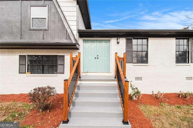 3862 Northstrand Dr, Decatur, GA 30035 - view of exterior entry featuring brick siding and crawl space