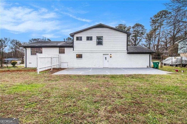 3862 Northstrand Dr, Decatur, GA 30035 - back of property featuring a lawn, a patio area, and brick siding