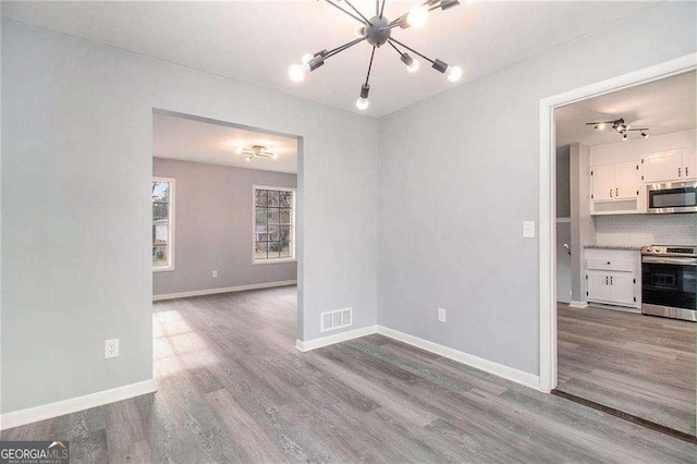 3862 Northstrand Dr, Decatur, GA 30035 - interior space with baseboards, a notable chandelier, visible vents, and wood finished floors