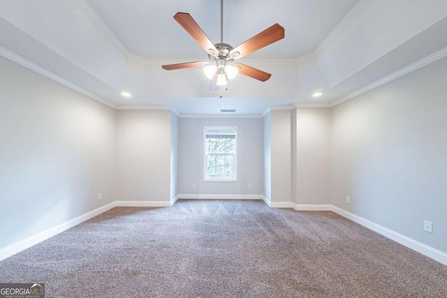 carpeted empty room featuring crown molding, baseboards, ceiling fan, recessed lighting, and a tray ceiling